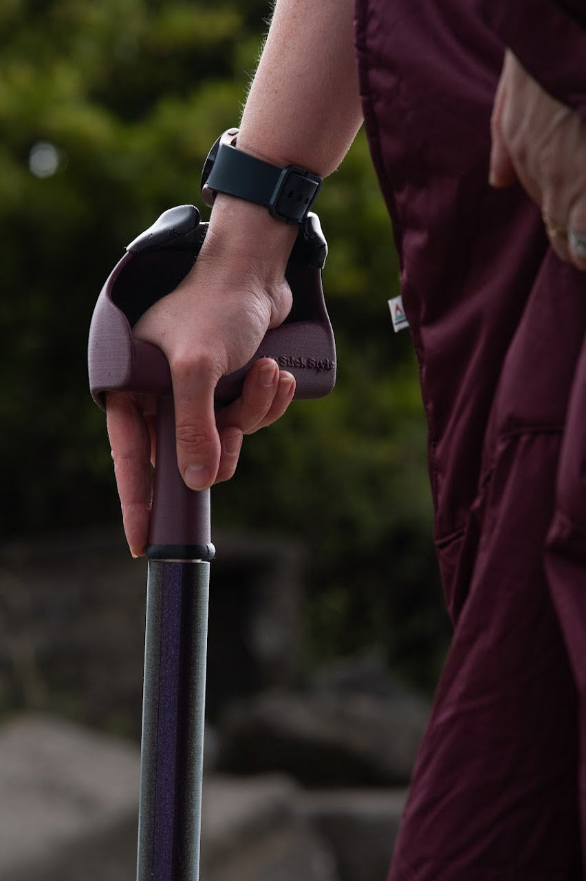 Stylish walking stick in burgundy, supportive and comfortable for everyday use.