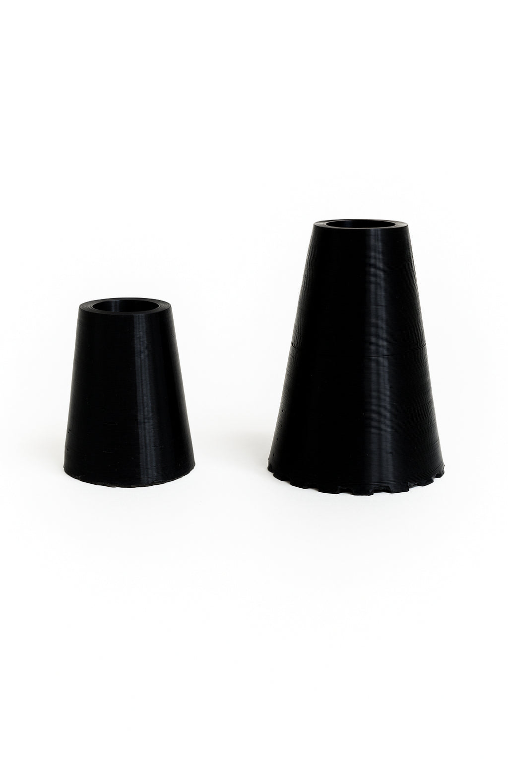 Two black walking stick ferrules in different sizes, small and large. Replacement rubber tips designed for My Stick Style walking sticks.